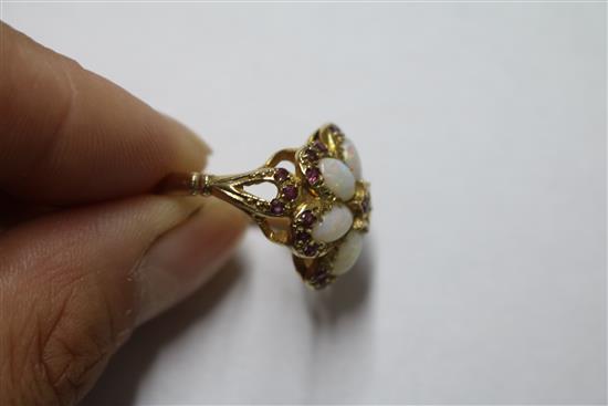 A 1970s 9ct gold, white opal and ruby cluster dress ring, size M.